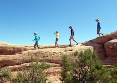 Escalante Yurts Jeep Rentals family climbing on rocks