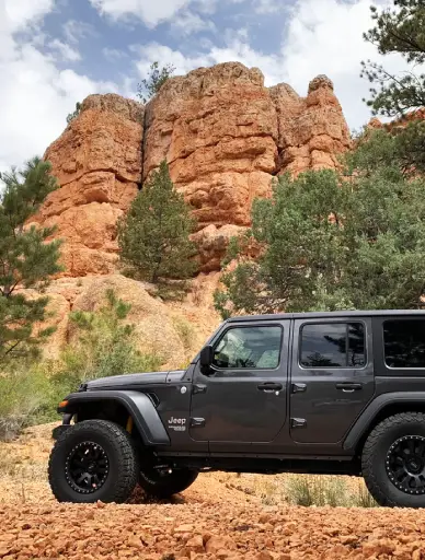 One of our jeep rentals parked outside a canyon.